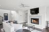 Living area featuring recessed lighting, stairway, a brick fireplace, ceiling fan, and wood finished floors