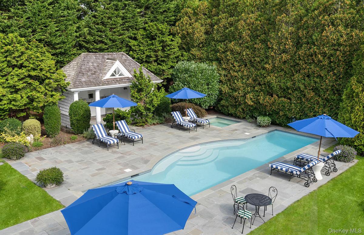 Outdoor pool with an outdoor structure and a patio area