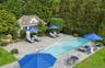 Outdoor pool with an outdoor structure and a patio area