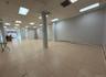 Basement featuring a drop ceiling and a baseboard heating unit
