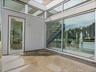 Entrance to property with stucco siding and a patio area