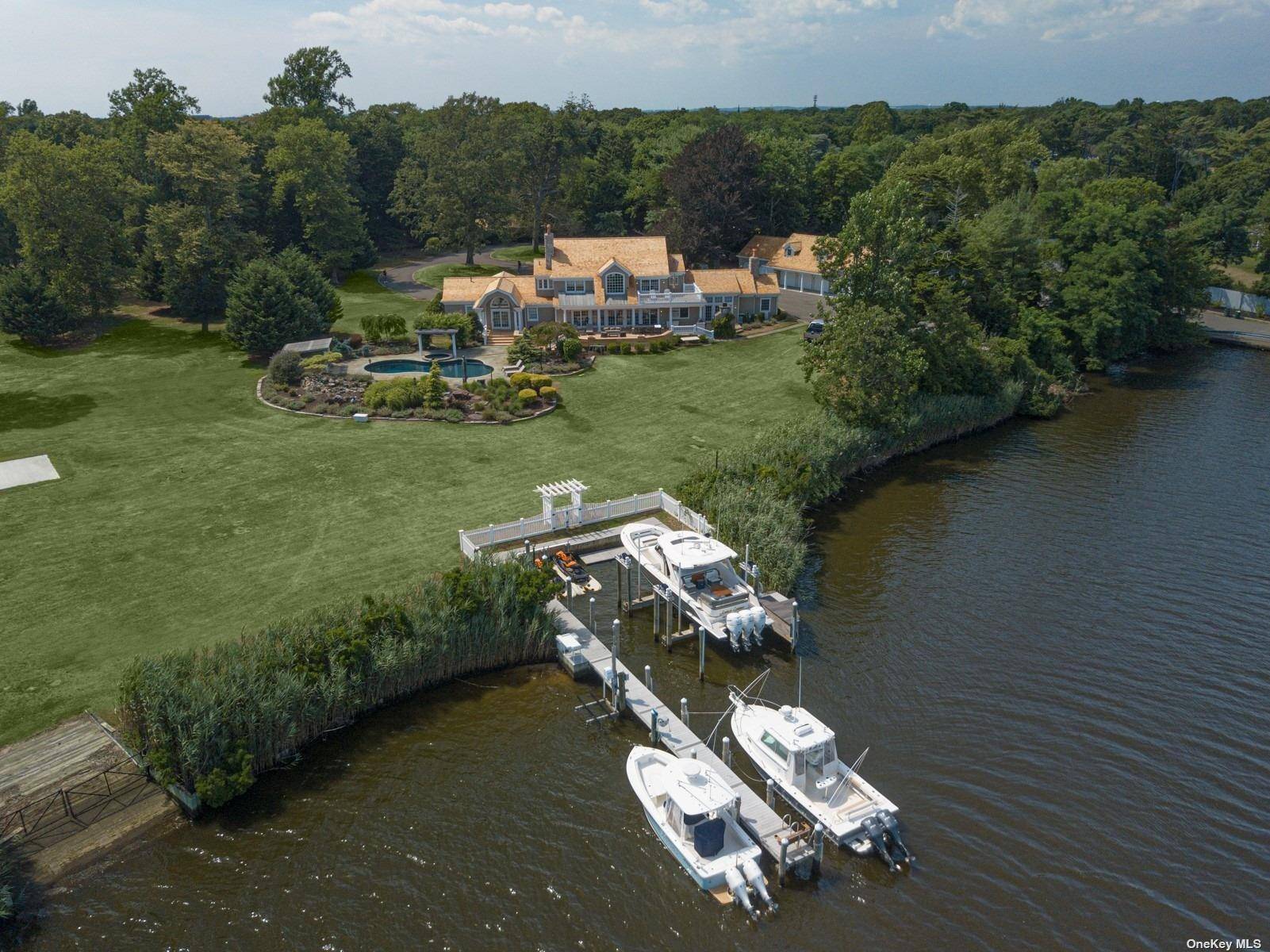 One of a kind cedar shake Hamptons style waterfront estate nestled on 4.