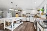 Kitchen with open shelves, backsplash, dark wood-style floors, pendant lighting, and white cabinets