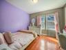 Bedroom featuring radiator and wood finished floors
