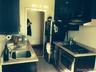 Kitchen featuring blue cabinetry, under cabinet range hood, and appliances with stainless steel finishes