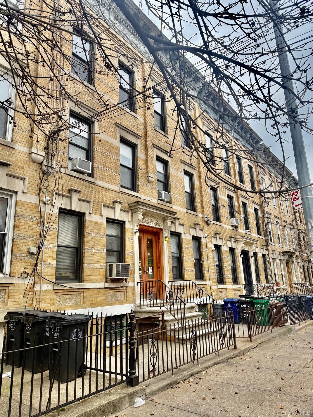 View of property featuring a fenced front yard and cooling unit