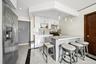 Kitchen featuring light marble finish flooring, a peninsula, stainless steel appliances, a breakfast bar area, and recessed lighting