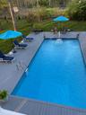 Outdoor pool featuring a yard and a deck