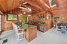 Kitchen with glass insert cabinets, a skylight, brown cabinetry, a breakfast bar, and wooden walls