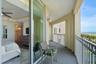 Seamless balcony access extends the primary suite outdoors, creating a peaceful connection to the coastline.