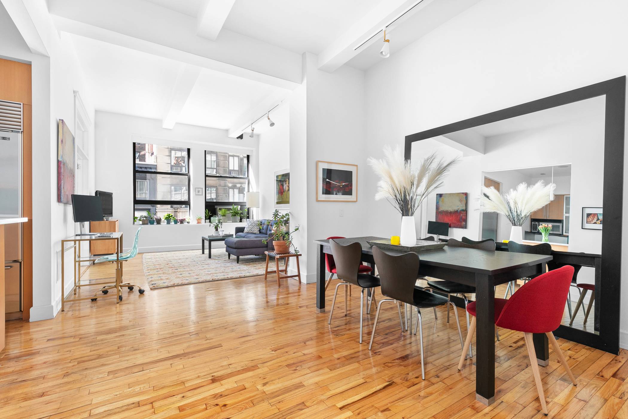 A voluminous and sun filled one bedroom loft with soaring ceilings in a full service prewar building in the heart of Flatiron.