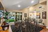 Spacious communal area featuring a tall vaulted ceiling and recessed lighting