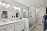 Primary bathroom through to walk in closet