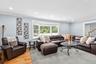 Living room with ornamental molding, light wood-type flooring, recessed lighting, stairway, and a baseboard heating unit