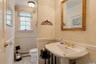 Bathroom featuring crown molding, wallpapered walls, tile patterned flooring, and baseboard heating