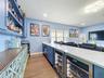 Wine coolers and ice maker complete this bar area