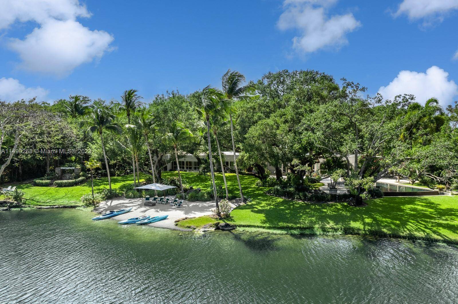 Sprawling 11, 734 total SF lakefront estate in the prestigious guard gated community of Snapper Creek, with unparalleled luxury and 5 BD, 5 BA and 2 HB.