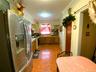 Kitchen with stainless steel refrigerator with ice dispenser, light countertops, crown molding, gas range, and light tile patterned flooring