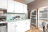 Kitchen featuring white cabinets, sink, and range with gas cooktop