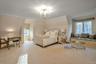 Carpeted bedroom featuring a notable chandelier and ornamental molding