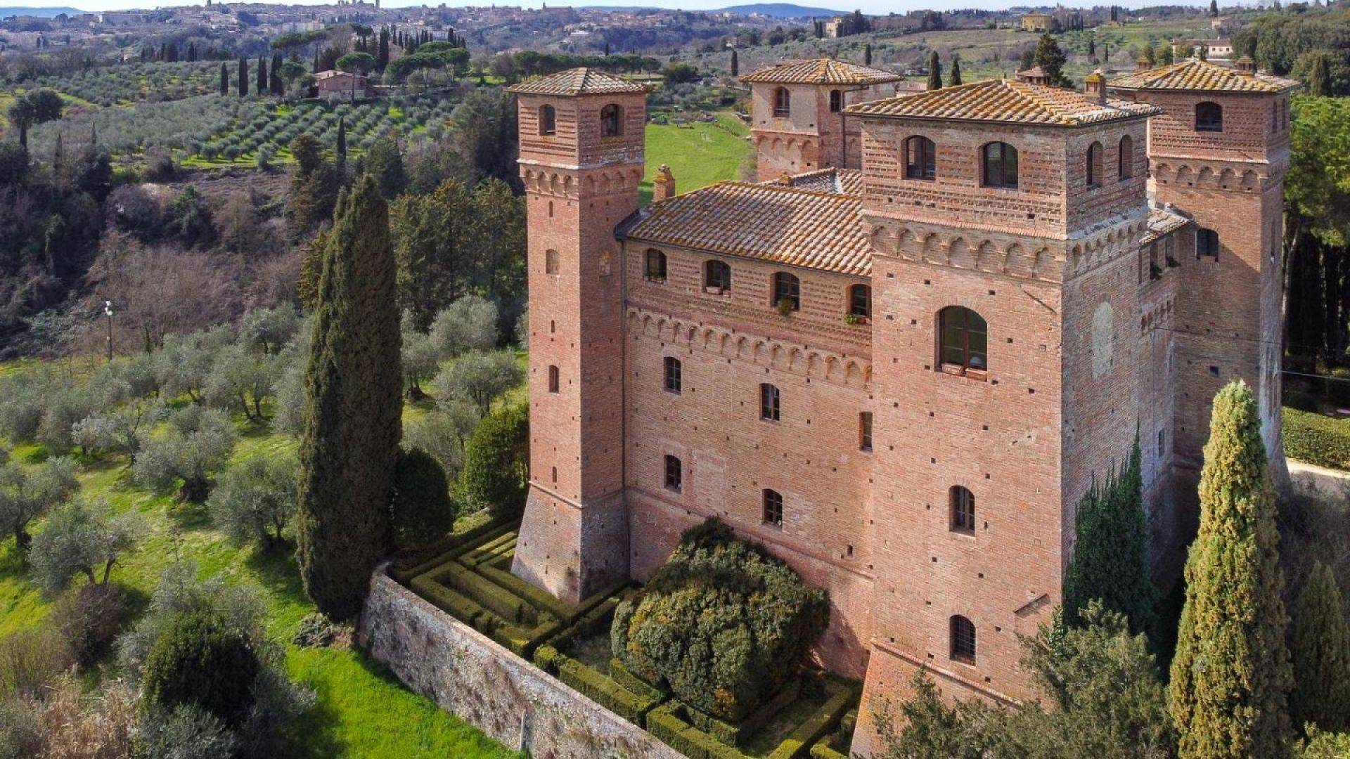 Remarkable and 'one-of-a-kind' property with a medieval castle featuring spectacular views of the city of Siena on sale in Tuscany.