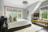 Bedroom featuring dark wood-style flooring and vaulted ceiling