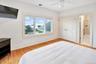 Third Oceanfront Bedroom featuring light wood-type flooring, ceiling fan, ensuite bathroom, recessed lighting, and a closet