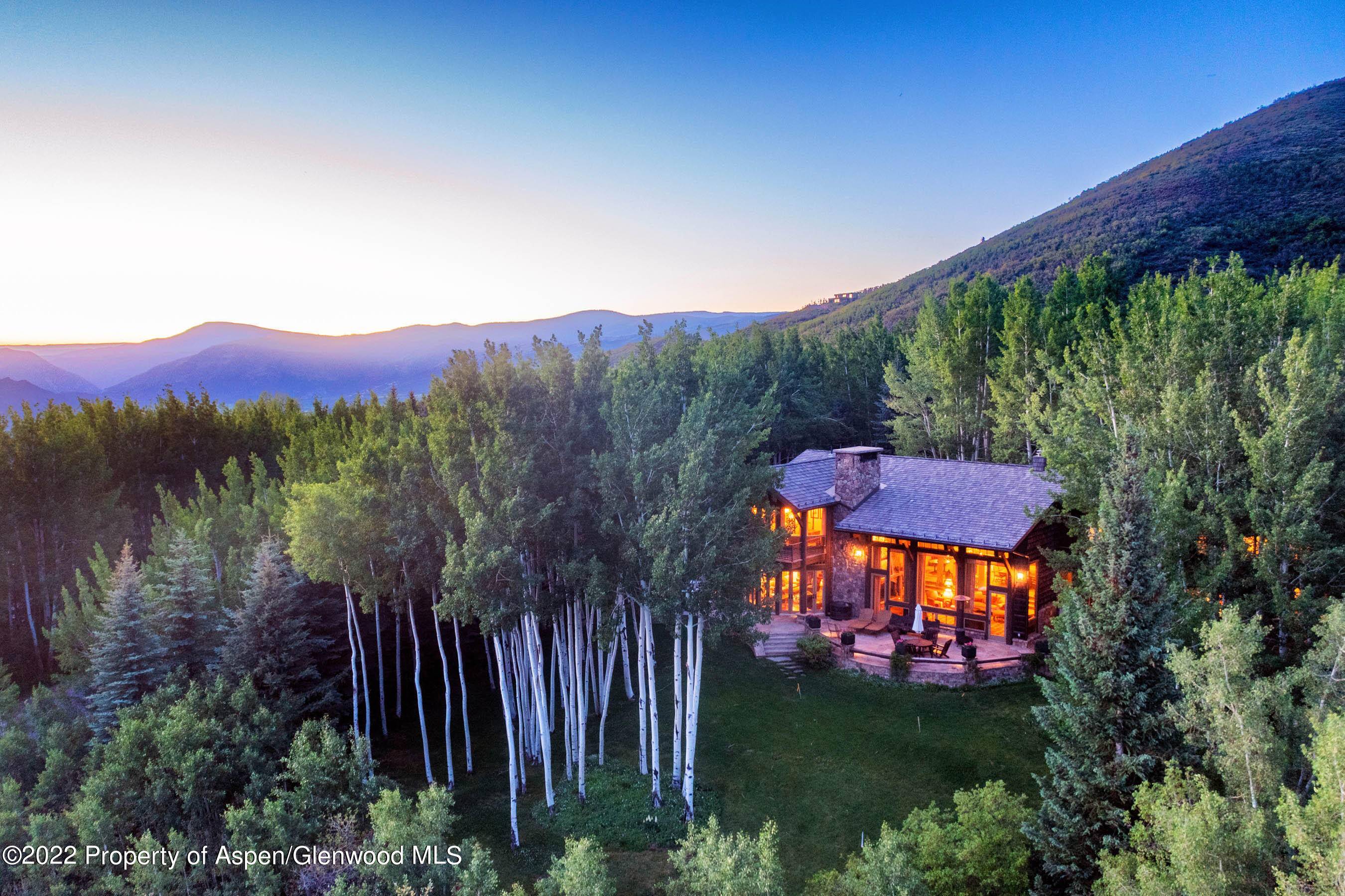 Elegant mountain estate privately situated on two park like acres surrounded by towering pines with stunning views of all four ski mountains and the Elk Mountain Range.