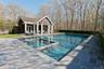 View of pool featuring a storage structure, an outdoor structure, a patio area, and a pool with connected hot tub
