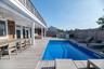 View of pool with a wooden deck, a grill, and ceiling fan