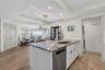 By opening the wall and extending the kitchen island, the design now draws your eye naturally toward the ocean views beyond.