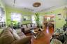 Living room featuring plenty of natural light, rail lighting, and hardwood / wood-style flooring
