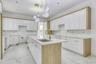 Kitchen featuring white cabinetry, hanging light fixtures, light marble finish flooring, and recessed lighting