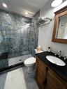 Bathroom with vanity, tile patterned flooring, and a stall shower