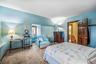 Carpeted bedroom with vaulted ceiling and radiator