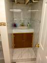 Bathroom featuring vanity and tile walls