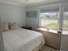 Bedroom with ornamental molding and ceiling fan