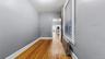 Hall with radiator and light wood-style flooring