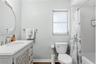En-suite bathroom with newer vanity and shower/tub combo.