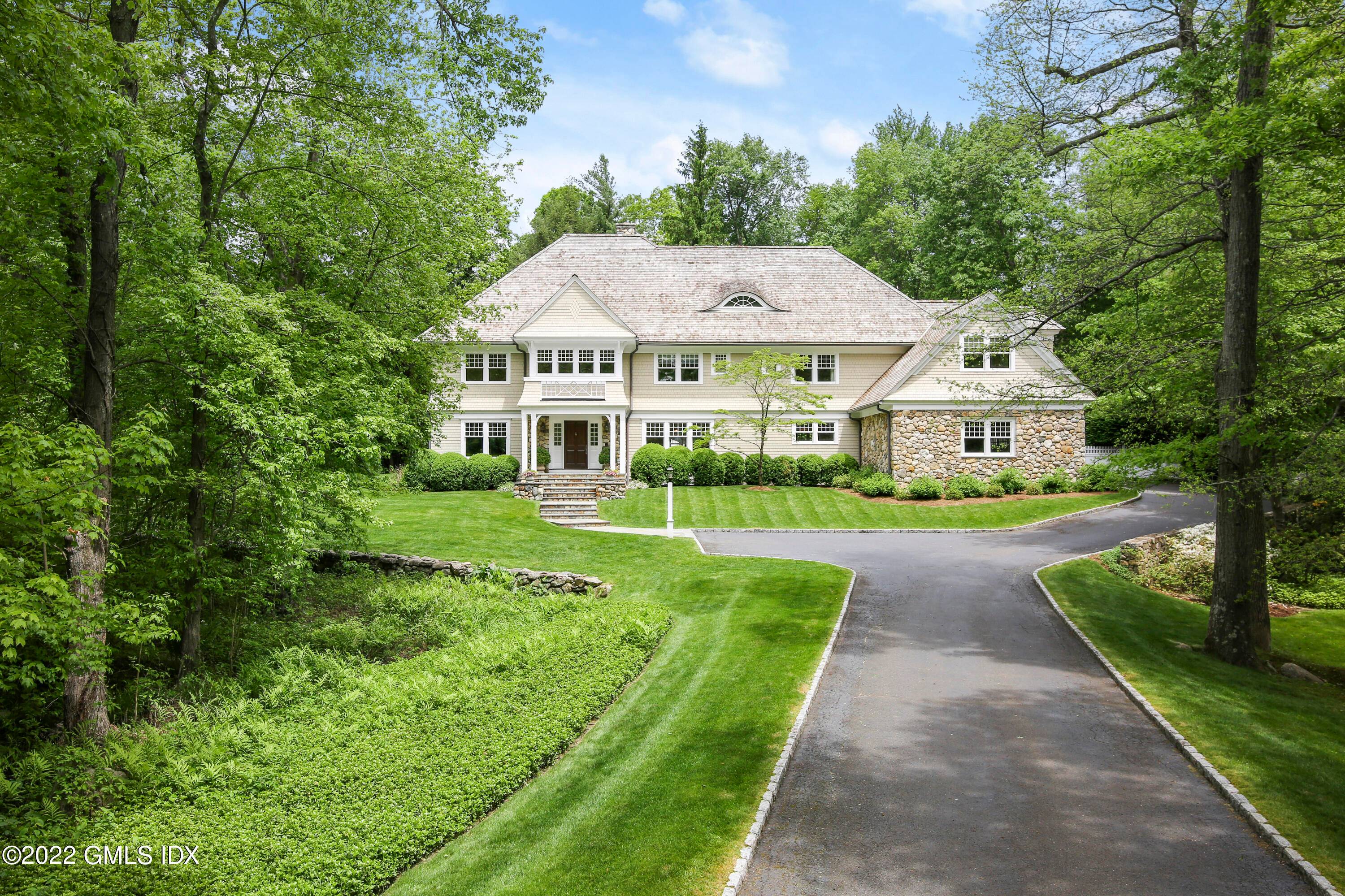 Stunning six bedroom stone shingle home, custom built by owners designed by noted architect, Neil Hauck, on coveted, circular lane neighborhood near town and schools.