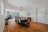 Open-concept living area featuring wood-finish flooring, recessed lighting, and a chandelier