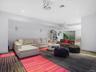 Carpeted living room featuring recessed lighting