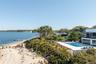 View of swimming pool featuring a fenced in pool and a water view