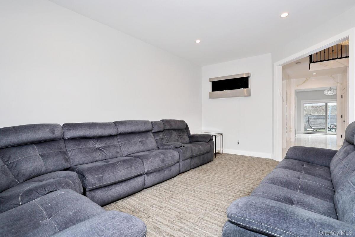 Living area with recessed lighting and carpet floors