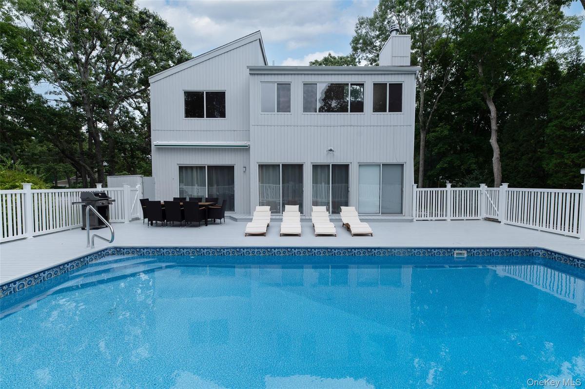 View of swimming pool featuring a fenced in pool, a patio area, outdoor dining area, and fence