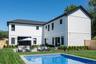 Back of property with a patio area, an outdoor pool, and a incredible sun.