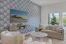 Living room featuring wallpapered walls, an accent wall, and recessed lighting
