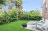 View of green lawn with a patio and an outdoor fire pit
