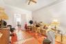 Office area with a ceiling fan, crown molding, and wood finished floors