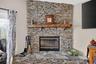 Wood burning stacked stone fireplace